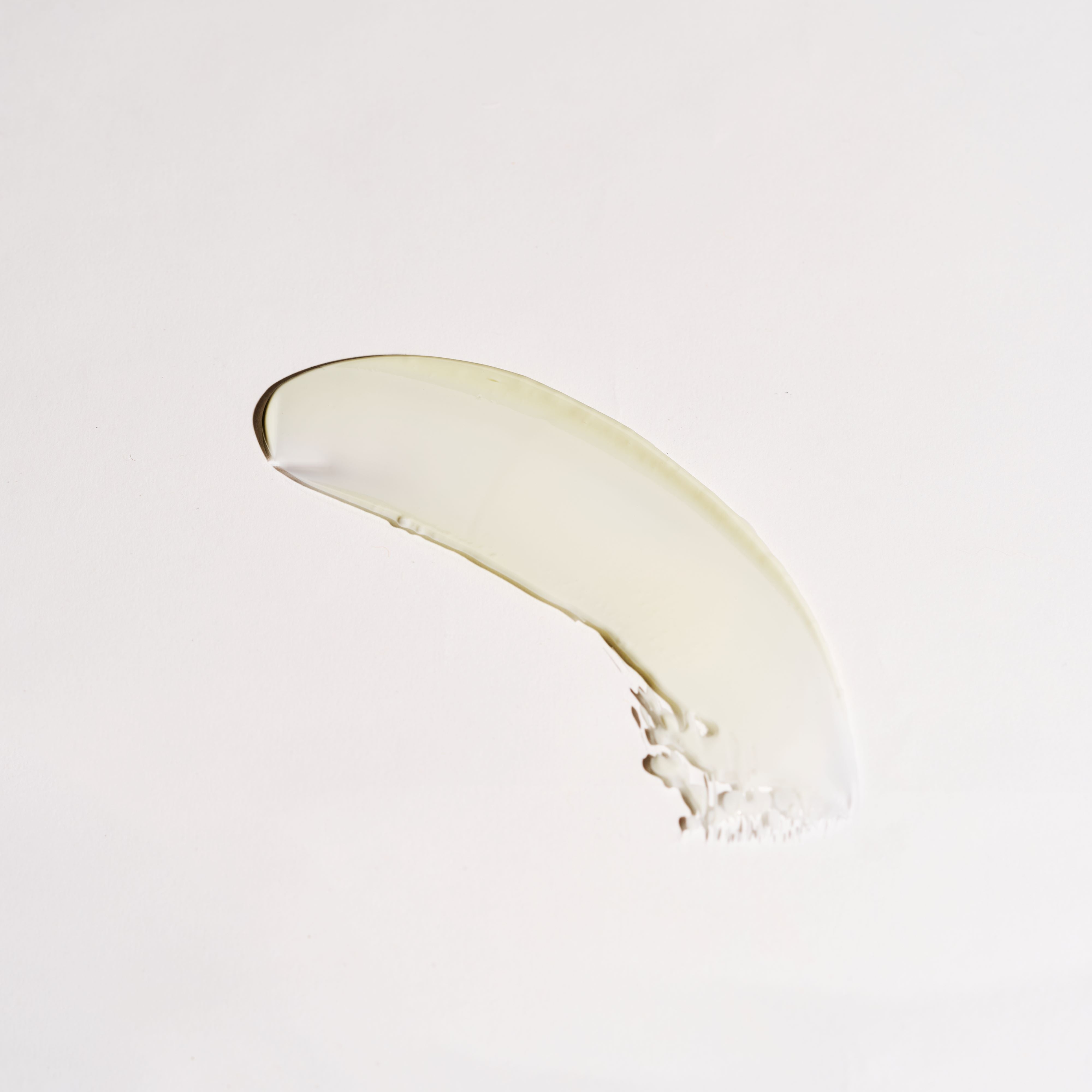 Close-up texture of Idoine organic anti-aging night cream with natural botanicals, showing smooth creamy formula on a white background