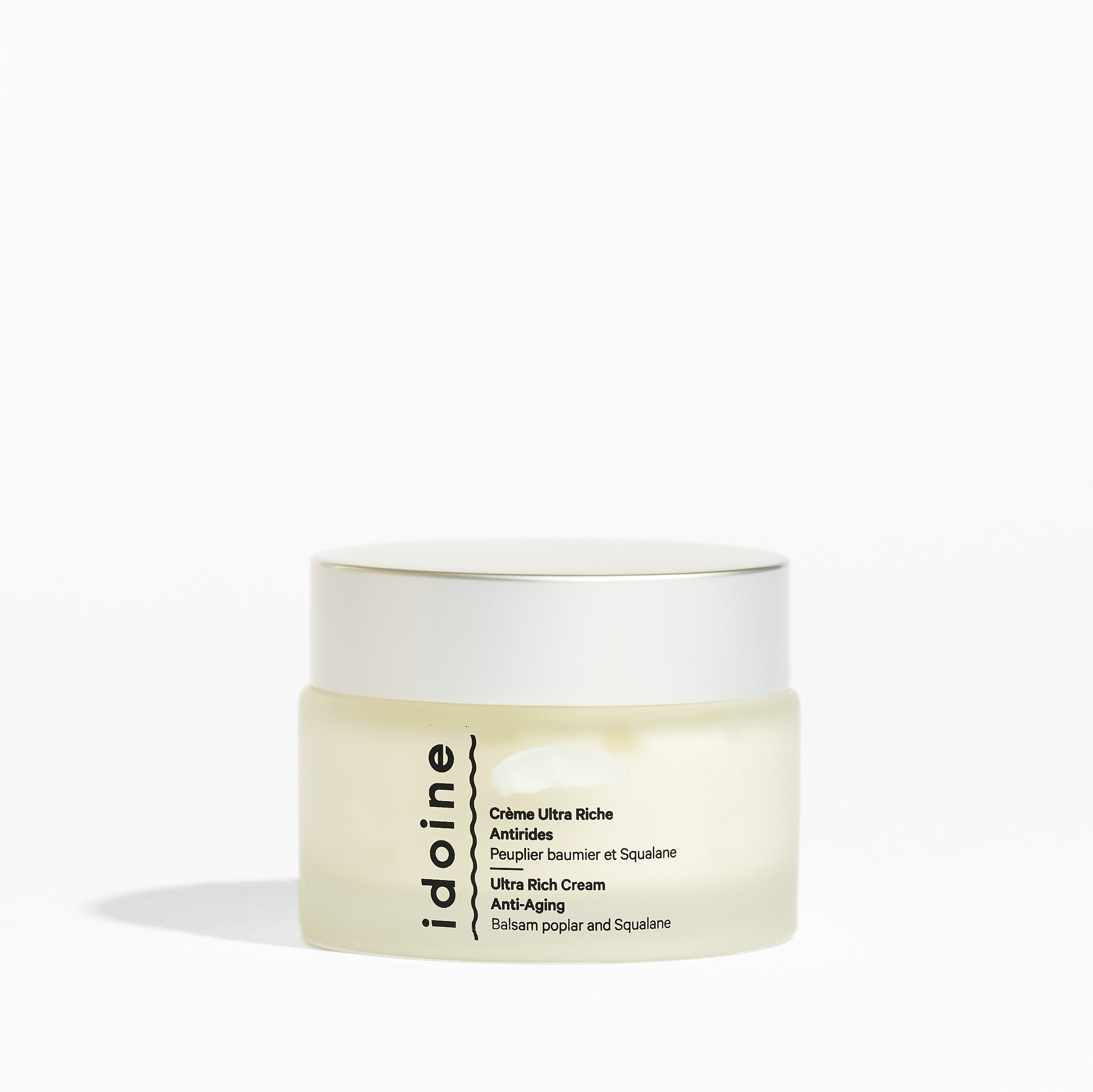 Idoine Bio ultra rich anti-aging cream in a frosted glass jar with white lid, enriched with balsam poplar and squalane for deep nourishment.